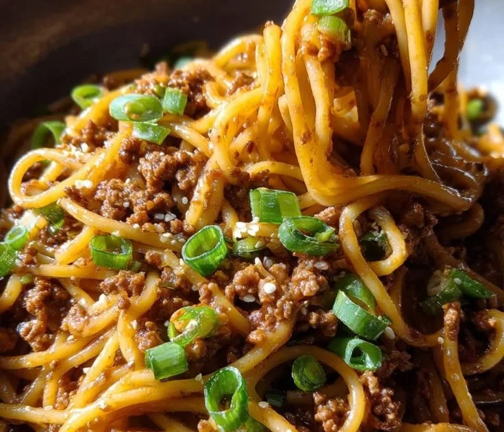Plate of Ground Beef Mongolian Noodles garnished with vegetables
