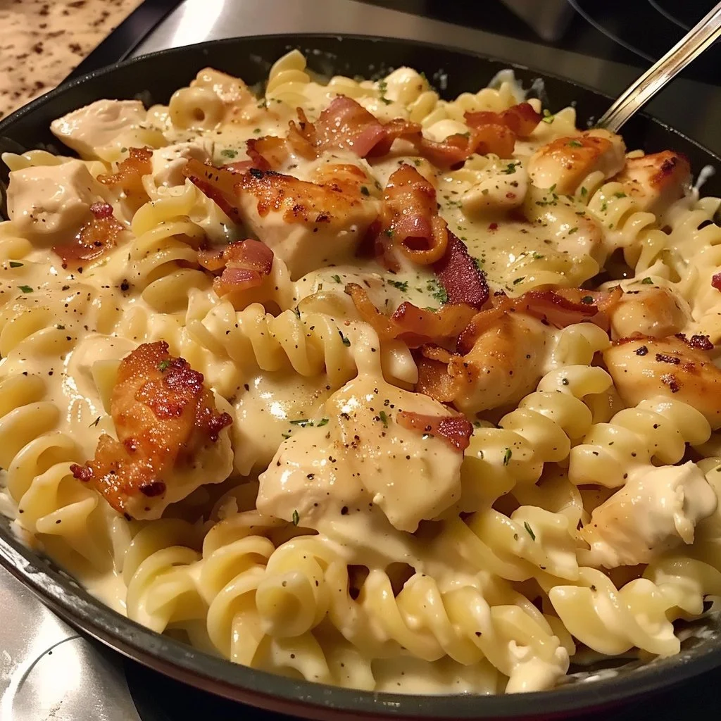 Creamy Chicken Bacon Ranch Pasta in a bowl with crispy bacon and fresh herbs.