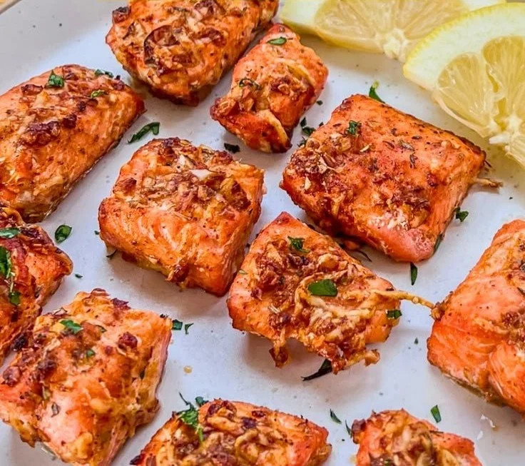 Crispy air fryer salmon bites served on a plate with dipping sauce