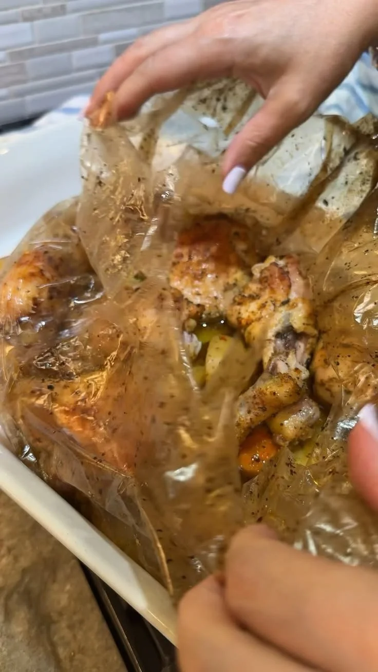 Delicious bag-cooked chicken with vibrant vegetables ready to serve.