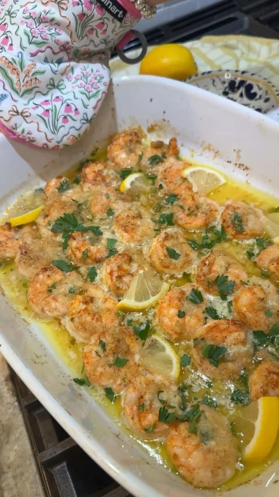 Baked shrimp scampi served with garlic and butter sauce on a plate