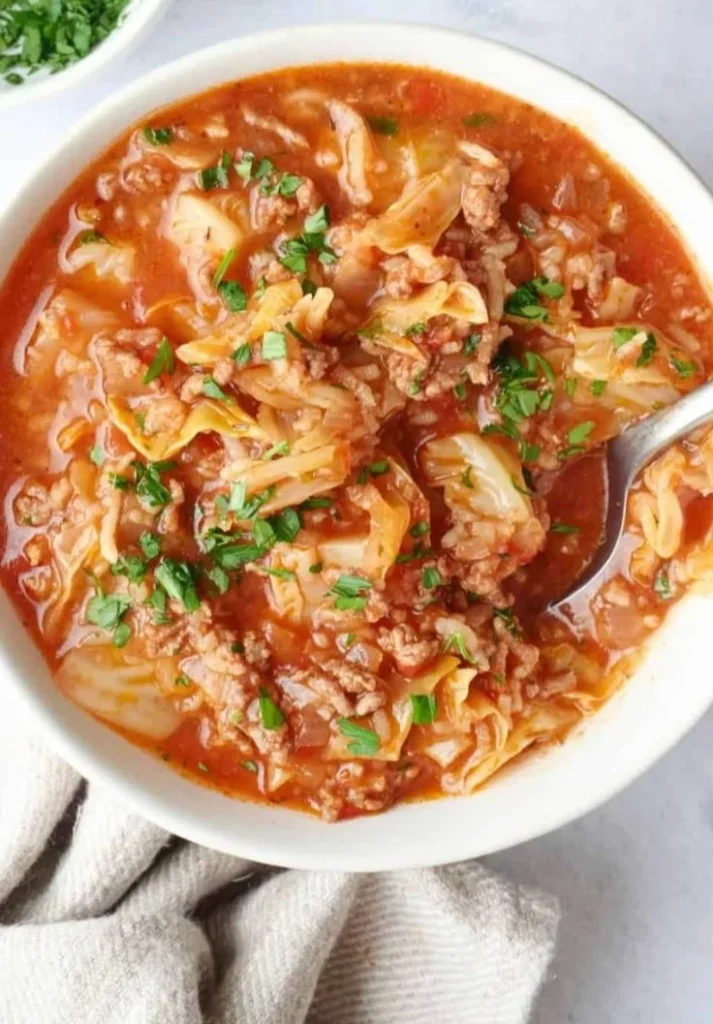 A bowl of delicious cabbage roll soup garnished with herbs and spices
