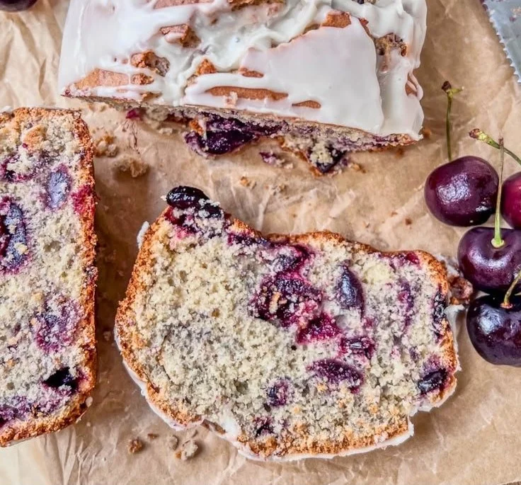 Freshly baked Cherry Vanilla Loaf Cake on a wooden table