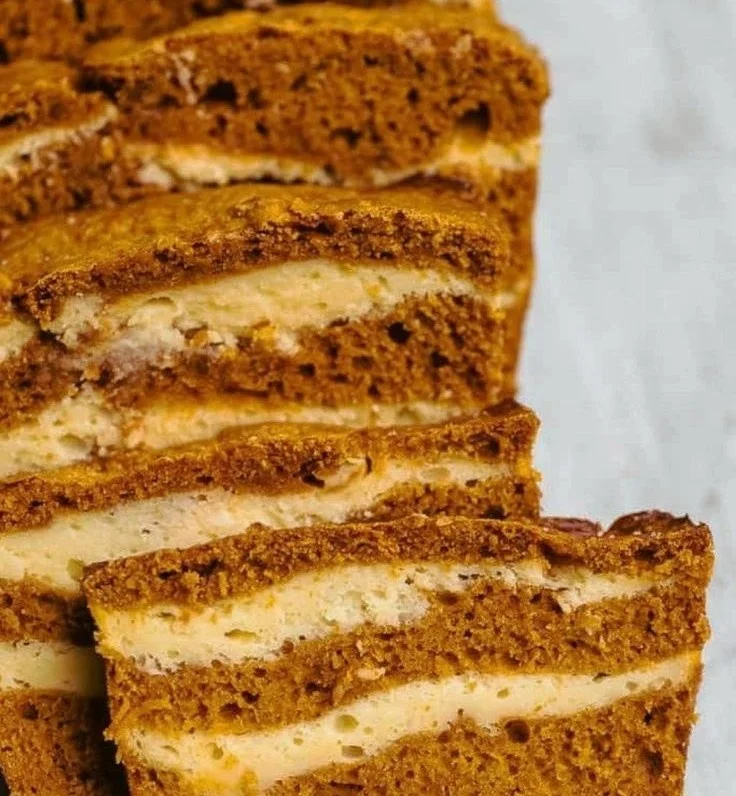 Slice of Cream Cheese Swirl Pumpkin Bread with a rich swirl of cream cheese