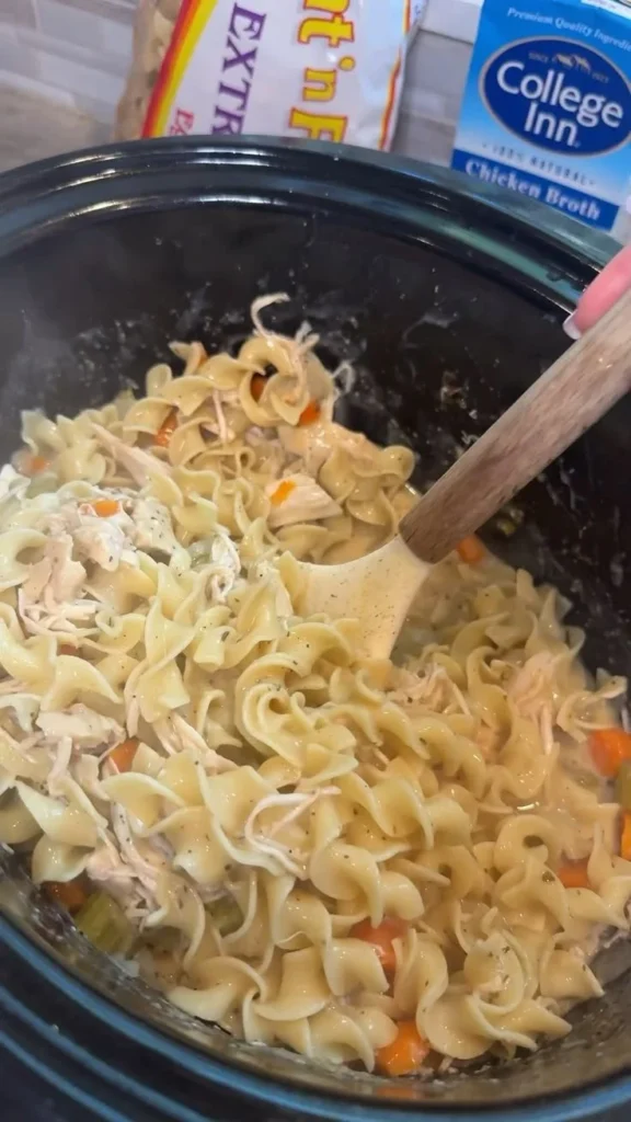 Creamy Crockpot chicken served with noodles in a bowl