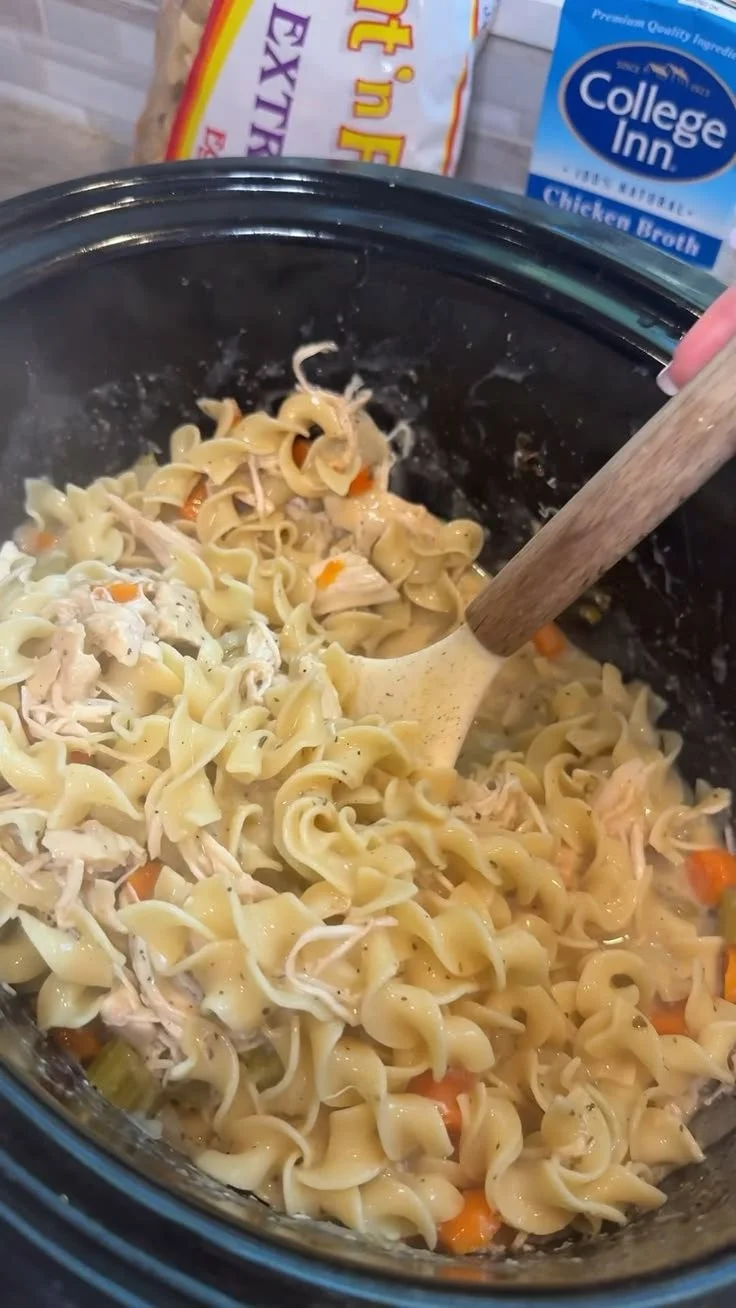 Creamy Crockpot chicken served with noodles in a bowl