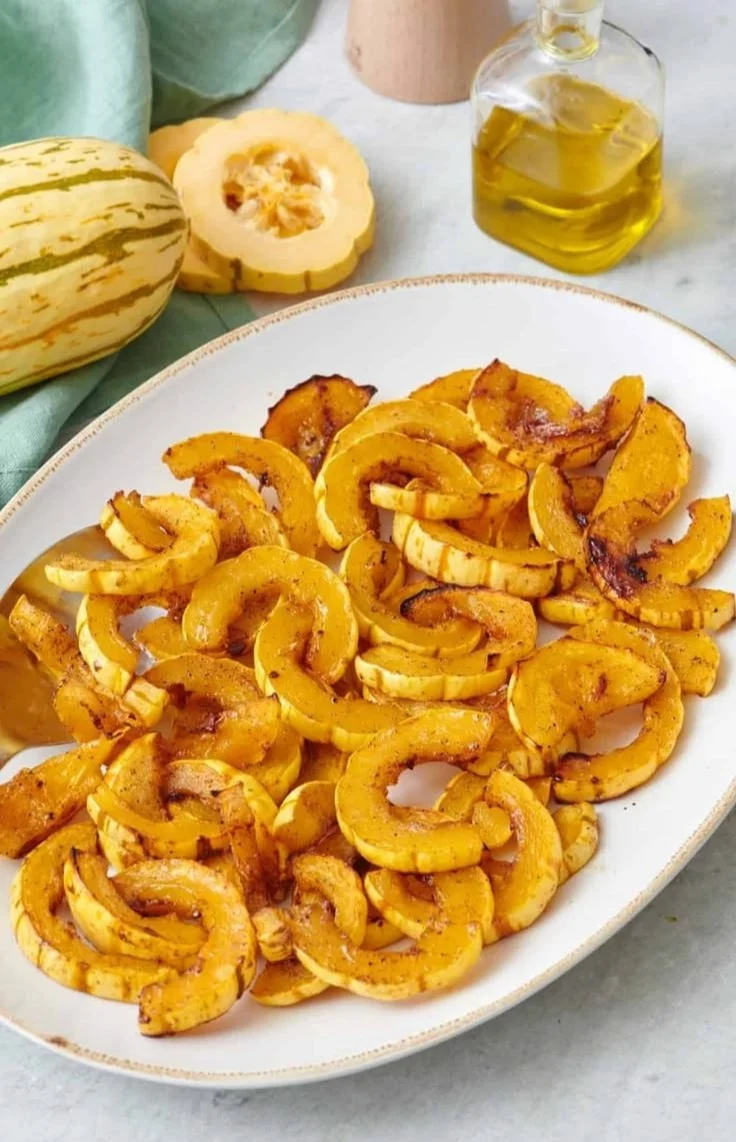 Deliciously roasted delicata squash arranged on a plate, ready to serve.