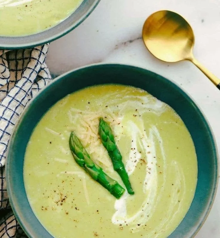 A bowl of elegant soup garnished with herbs and spices, perfect for fine dining.