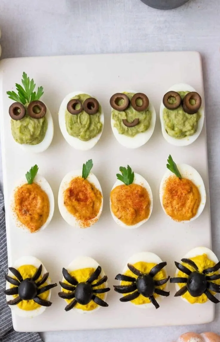 Halloween-themed deviled eggs decorated for a spooky celebration
