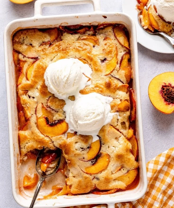 Delicious peach cobbler with flaky crust and fresh peaches served in a baking dish