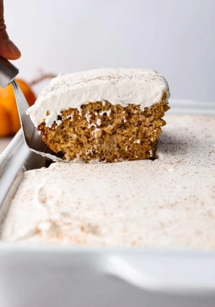 Delicious Pumpkin Three-Milk Cake topped with cream and spices.