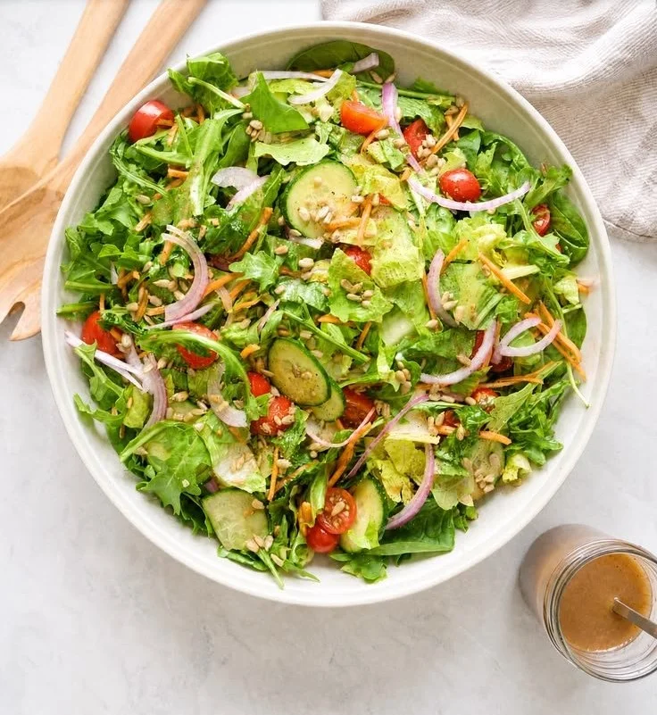 Fresh simple green salad with balsamic vinaigrette dressing on a plate