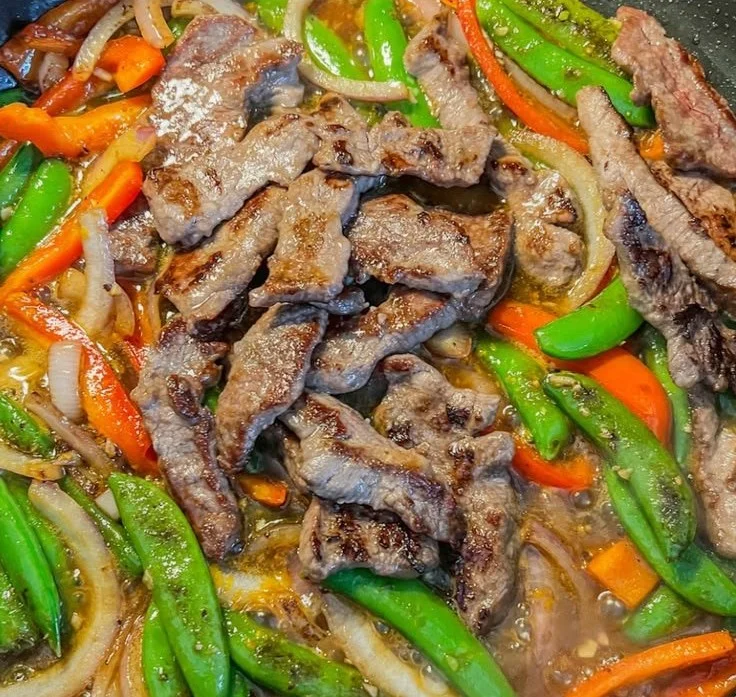 Delicious sticky orange beef stir-fry served with rice and vegetables